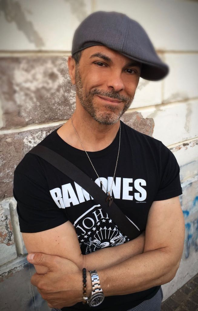 Lux Von Alchemy wearing a hat and Ramones T-shirt